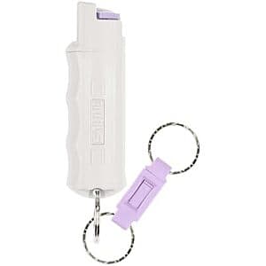 SABRE Red OC pepper spray canister with attached quick release keychain in black and red packaging.