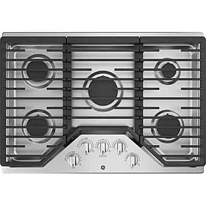 Stainless steel GE 30" 5-burner built-in gas cooktop with dishwasher-safe grates and control knobs on the front.