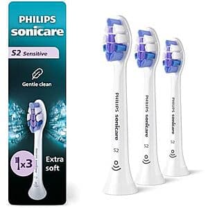 Three white Philips Sonicare S2 replacement toothbrush heads with black trim and bristles in product packaging.