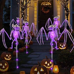 Two 3D black skeleton bat decorations with solar-powered LED path lights mounted on stakes for outdoor garden display.