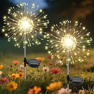 Two sets of warm white solar-powered firework fairy lights with 120 LEDs each, featuring exploding starburst design for garden decoration.