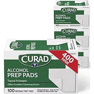 Four boxes of Curad alcohol prep pads, each containing 100-count individual pads, displayed against a plain background.