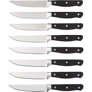 Eight stainless steel serrated steak knives with black handles arranged in a set, featuring full tang construction and 4.5-inch blades.