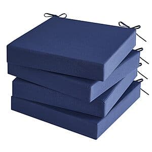 Four navy blue outdoor patio chair cushions, 19 inches, stacked together showing the fabric texture and color.