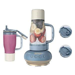 Ninja tumbler blender system with compact white base, 1200-watt motor, and two 26oz black Blendboss tumblers with matching leak-proof chug and straw lids.