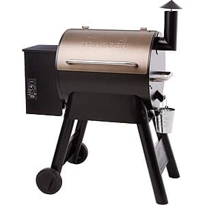 Traeger Pro Series 22-inch bronze pellet grill with sawhorse chassis, side-lift bar, and all-terrain wheels.