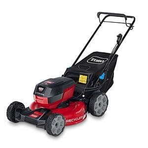 Self-propelled lawn mower with black deck and brushless motor, featuring a vertical storage-ready design with 6.0 Ah battery pack.