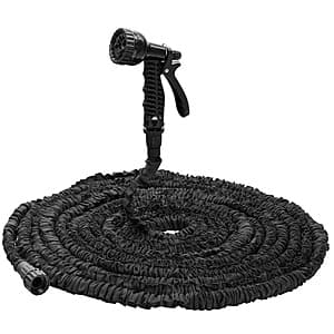 100-foot lightweight expandable garden hose in coiled compact form with attached 7-pattern adjustable spray nozzle featuring black rubberized grip.