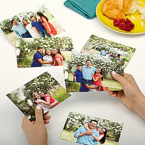 Stack of 4x6 glossy photo prints in standard white packaging.