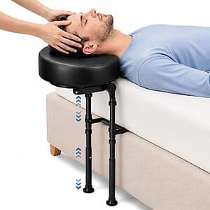 HAIZE black bedside massage headrest with face-cradle design for prone positioning at edge of bed.