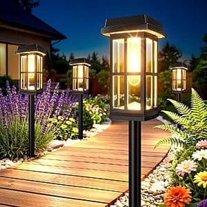 Eight-pack of black solar LED pathway lights with stake design, suitable for outdoor garden or pathway lighting.