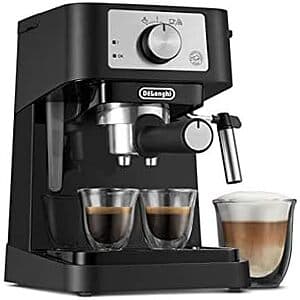 De'Longhi Stilosa silver and black manual espresso machine with integrated milk frother and included tamper accessory.