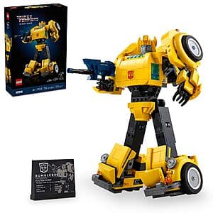Yellow and black LEGO Transformers Bumblebee articulated action figure with ion blaster and jetpack accessories, displayed on a plaque.