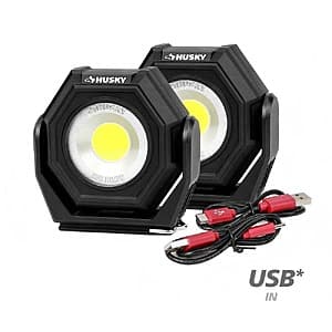 Two compact Husky rechargeable utility lights with built-in magnets and three-mode LED display, dark gray and black finish.