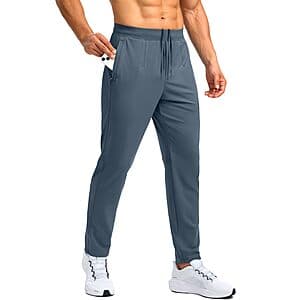 Bronze green men's stretch workout pants with two side zipper pockets, showcasing the athletic fit and fabric texture.