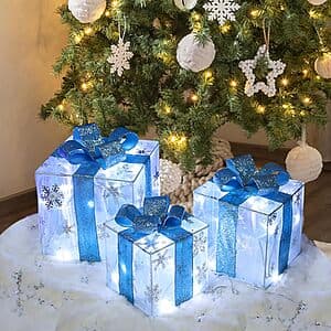 Three illuminated Christmas gift box decorations in cool white, each featuring LED lights, designed for indoor and outdoor holiday display.