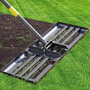 Stainless steel lawn leveling rake with 30-inch-wide head and adjustable handle extended, showing the tool's heavy-duty construction.