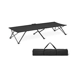 Black twin-size folding camping cot with metal frame and fabric surface, in compact folded position.