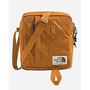 The North Face Berkeley Crossbody Bag in black with adjustable shoulder strap and front storage pocket.