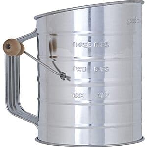 GoodCook hand crank sifter with wood knob and tin body, showing 3-cup capacity markings.