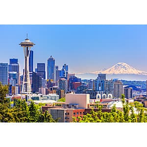 Airplane in flight with clear skies, representing air travel between Seattle and San Diego.