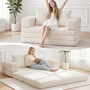Beige boneless convertible loveseat sofa bed with removable armrests and backrest in closed position.