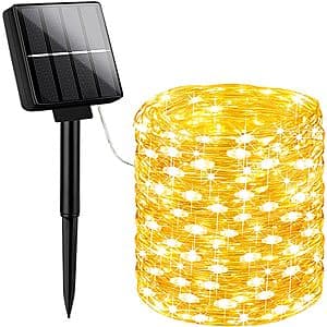 40-foot string of 100 warm white LEDs attached to solar-powered units, displaying outdoor garden lighting with multiple bulbs strung in a line.