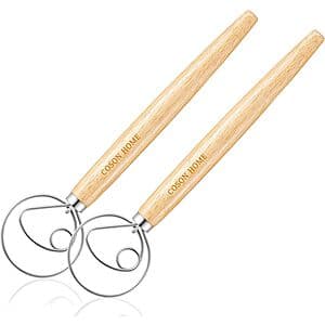 Two wooden hand whisks with traditional Danish dough whisk design, featuring natural wood construction.