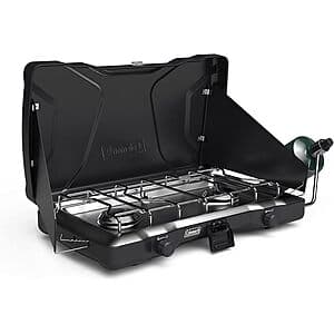 Coleman Triton portable propane stove with two burner heads and control knobs, compact camping stove design.
