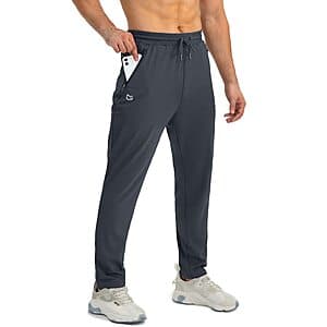 Men's tapered jogger sweatpants in charcoal or navy with 4-way stretch fabric, featuring three zipper pockets, displayed in various sizes.