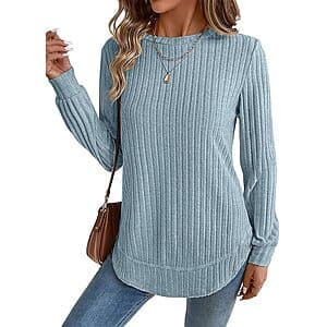 Lightweight long-sleeve top with crew neck, loose fit, and curved tunic-length hem suitable for pairing with leggings or jeans.