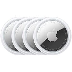 Four white circular Apple AirTags with Apple logo, displayed together showing compact design and plastic loop attachment points.