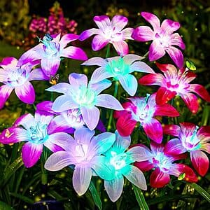 Four solar-powered lily flower garden lights with green stems and petals that change through seven colors, designed for outdoor garden decoration.
