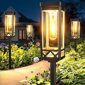 KOOPER 8-pack solar LED pathway lights in warm white, with black plastic solar tops and stakes for outdoor ground installation.
