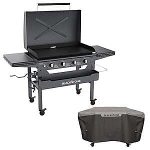 Black preseasoned omnivore griddle with soft cover, front accessory shelf, and integrated magnetic shelf system.