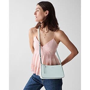 Kate Spade Ginnie Crossbody Bag in one of five available colors, featuring a classic crossbody design with structured shape and adjustable strap.