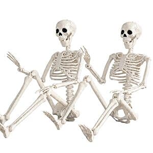 Two white plastic 36-inch skeleton decorations with matte textured bone-like finish and movable joints, displayed in standing position.
