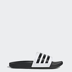adidas Men's Adilette Comfort Slides in a neutral colorway, showing the cushioned strap and sole design.