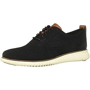 Cole Haan 2.Zerogrand Lightweight Oxford dress shoe in black with ivory accents, displayed from the side.