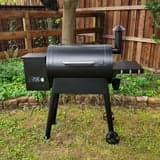 Member's Mark 28-inch wood pellet grill with black exterior, porcelain-coated steel grates, warming rack, and LCD control panel.