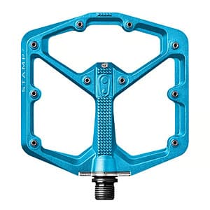 Large blue mountain bike pedals with aggressive pin grip surface, showing wide platform and multiple grip pins for foot control.