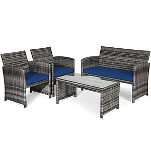 Four-piece rattan patio furniture set featuring a loveseat, two single chairs with thick cushions, and a coffee table with tempered glass top in various colors.