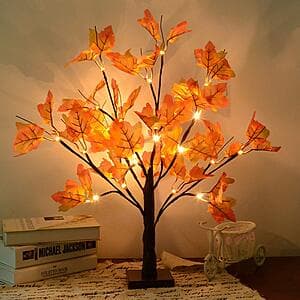 Artificial fall maple tree with warm LED lights, decorated for autumn and harvest celebrations.