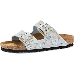 Birkenstock Women's Arizona sandals in baby blue suede with delicate flower print design, featuring cork footbed and dual buckle straps.
