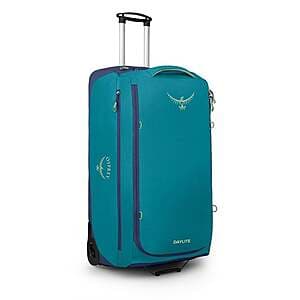 Osprey Daylite 115L wheeled collapsible travel duffel bag in blue colorway with alkaline accents, featuring expandable sides and integrated wheels.